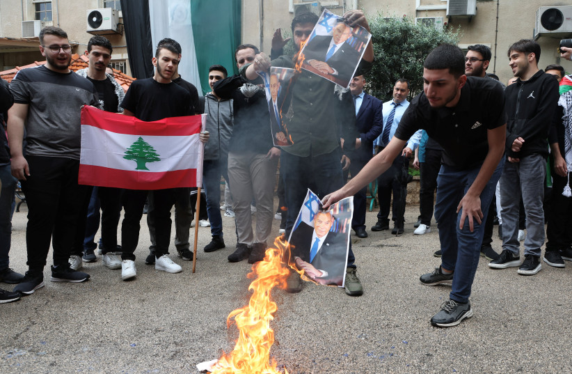  A demonstrator burns a picture depicting Israeli Prime Minister Benjamin Netanyahu during a protest in solidarity with Gaza at the Lebanese American University (LAU), in Beirut, Lebanon April 30, 2024. (credit: REUTERS/MOHAMED AZAKIR)