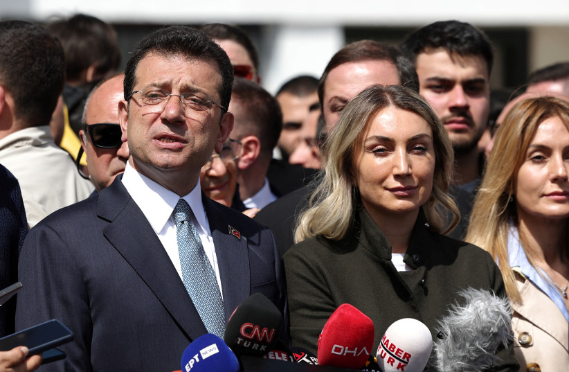  Istanbul Mayor Ekrem Imamoglu, mayoral candidate of the main opposition Republican People's Party (CHP), accompanied by his wife Dilek Imamoglu, talks to media after casting his vote during the local elections in Istanbul, Turkey March 31, 2024. (credit: REUTERS/MURAD SEZER)