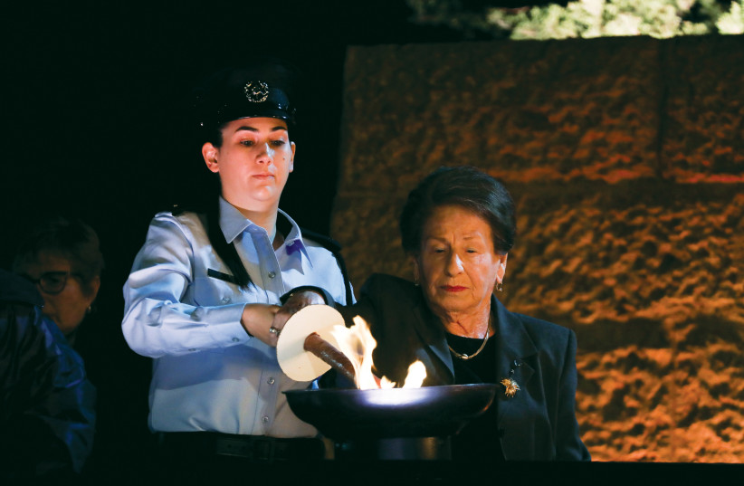  A SURVIVOR lights a torch at Yad Vashem on Holocaust Remembrance Day 2021.  (credit: OLIVIER FITOUSSI/FLASH90)