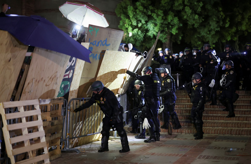  Riot police take down the barricade as protesters supporting Palestinians in Gaza gather at an encampment at the University of California Los Angeles (UCLA), amid the conflict between Israel and the Palestinian Islamist group Hamas, in Los Angeles, California, US, May 2, 2024. (credit: REUTERS/MIKE BLAKE)