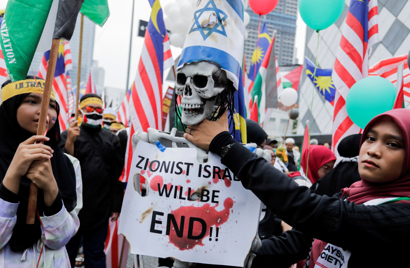  A person holds the neck of an artificial human skeleton during the al-Quds day (Jerusalem Day), an annual pro-Palestinian event held on the last Friday of the Islamic holy month of Ramadan to express support for Palestinians and oppose Israel and Zionism in Kuala Lumpur, Malaysia April 14, 2023 (credit: REUTERS/Hasnoor Hussain)