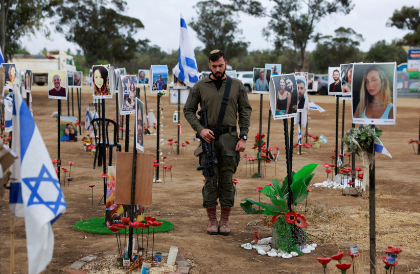 An Israeli soldier stands during a two-minute siren marking the annual Israeli Holocaust Remembrance Day, at an installation at the site of the Nova festival where party goers were killed and kidnapped during the October 7 massacre by Hamas terrorists, in Reim, southern Israel, May 6, 2024.  (credit: AMMAR AWAD/REUTERS)