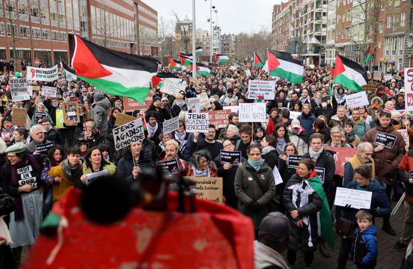  Demonstrators hold placards and Palestinian flags as they protest near the Portuguese Synagogue on the day of the opening of the National Holocaust Museum, in Amsterdam, Netherlands, March 10, 2024. (credit: REUTERS/HILDE VERWEIJ)