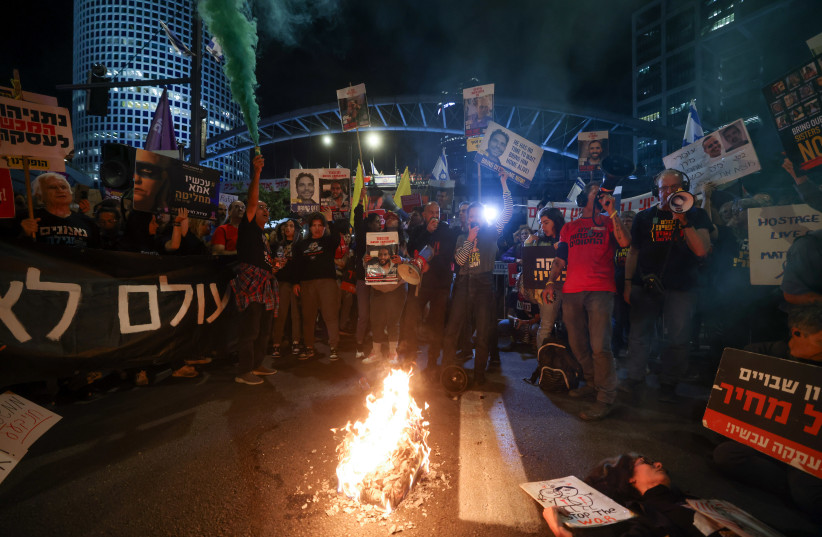 Demonstrators protest calling for the release of Israeli hostages held in the Gaza Strip seen blocking the Ayalon highway in Tel Aviv, May 6, 2024 (credit: Chaim Goldberg/Flash90)