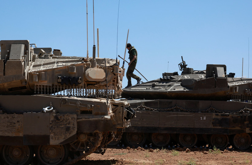 IDF soldiers gather next to tanks near the Israel-Gaza border, May 8, 2024
