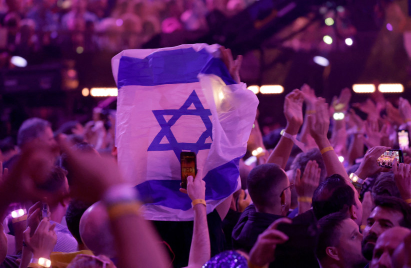  A member of the audience holds an Israeli flag during the second semi-final of the 2024 Eurovision Song Contest, in Malmo, Sweden, May 9, 2024. (credit: Leonhard Foeger/Reuters)