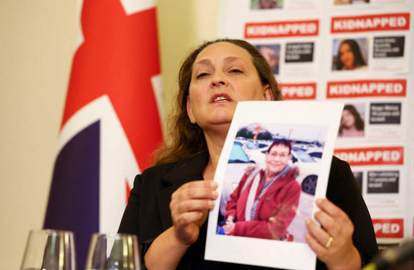 Ayelet Svatitzky shows a picture of her mother Channah Peri during a press conference of family members of British-Israeli kidnap victims, amid the ongoing conflict between Israel and the Palestinian Islamist group Hamas, at the Israeli Embassy in London, Britain October 24, 2023.  (credit: Hannah McKay/Reuters)