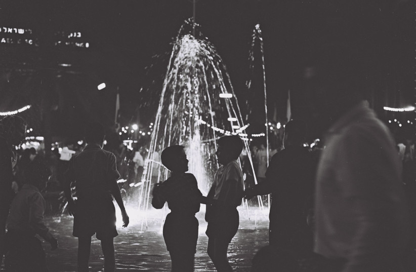 Tel Aviv children milling around the illuminated fountain in Dizengoff Square, on the eve of Independence Day 1966 (credit: Cohen Fritz/GPO)