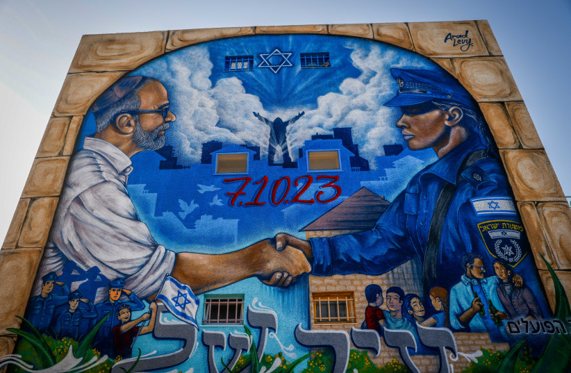  View of a graffiti in the southern Israeli city of Ofakim, December 4, 2023 (credit: Chaim Goldberg/Flash90)