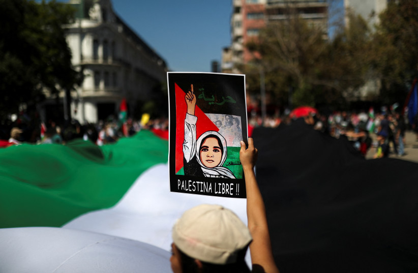  A demonstrator holds up a sign reading 'Free Palestine' during a march rally in support of Palestinian people in Gaza, amid the ongoing conflict between Israel and Hamas, in Santiago, Chile, March 17, 2024.  (credit: REUTERS/Vanessa Rubilar)