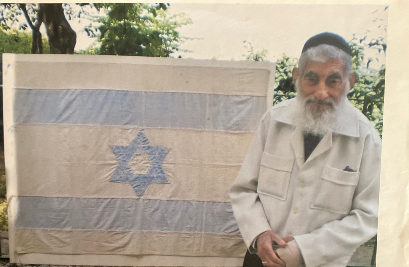  Ezra Gorodesky with the Israeli flag made by Rebecca Affachiner. (credit: COURTESY DAVID GEFFEN)