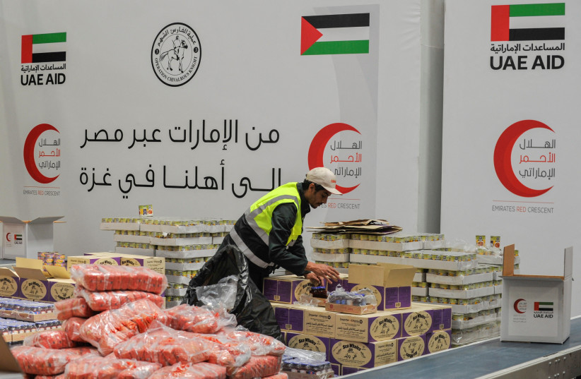  A volunteer from Emirates Red Crescent prepares parcels with humanitarian aid for Gaza to be transferred through the Rafah border crossing between Egypt and the Gaza Strip, in Cairo, Egypt, March 30, 2024. (credit: REUTERS/SHOKRY HUSSEIN)