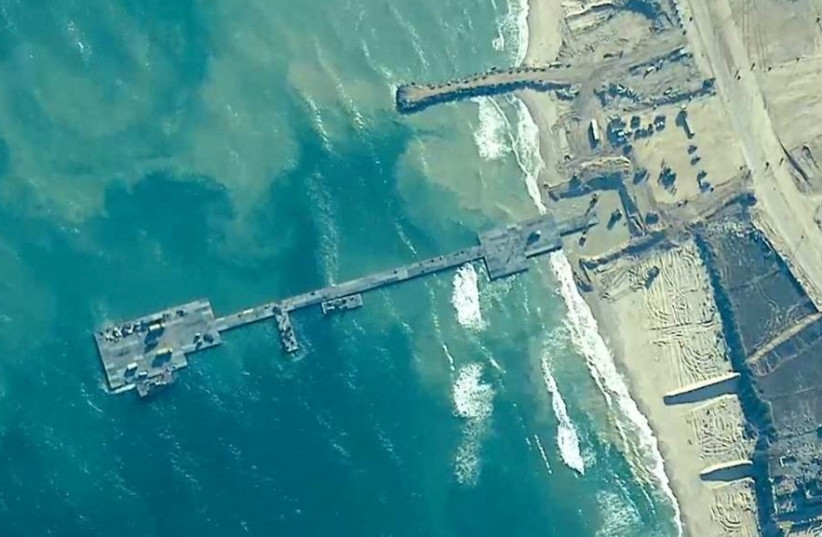 Members of the U.S. Army, U.S. Navy and the Israeli military put in place the Trident Pier, a temporary pier to deliver humanitarian aid, on the Gaza coast, amid the ongoing conflict between Israel and the Palestinian Islamist group Hamas, May 16, 2024. (credit: US CENTRAL COMMAND/HANDOUT VIA REUTERS)