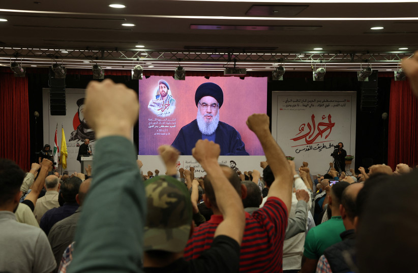  Supporters of Lebanon's Hezbollah leader Sayyed Hassan Nasrallah gesture as Narallah gives a televised address during a rally in Beirut's southern suburbs, Lebanon May 13, 2024. (credit: MOHAMED AZAKIR/REUTERS)