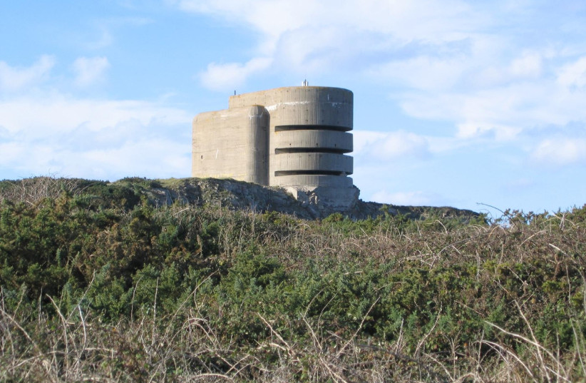 German WW2 bunker 'The Odeon' in Alderney. This is about 3 or 4 storeys high and has an anti-aircraft emplacement at the back. Alderney is said to have been the most heavily fortified of the Channel Islands. At one time the allies contemplated landing there as a rehearsal for D-Day. (credit: Wikimedia Commons)