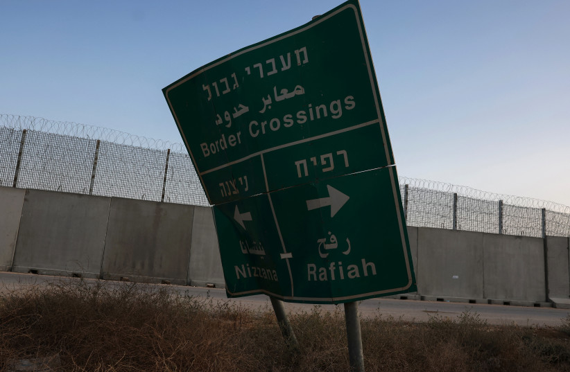  A damaged road sign stands at the Kerem Shalom border crossing, as military operations continue in the southern Gaza city of Rafah, at an area outside Kerem Shalom, Israel, May 17, 2024. (credit: SHANNON STAPLETON/ REUTERS)