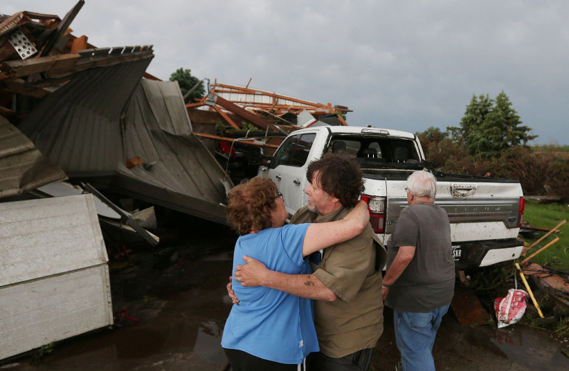  June Handsaker consoles his brother Larry Handsaker after a tornado damaged his house in Nevada, Iowa, US May 21, 2024.  (credit: Nirmalendu Majumdar/Ames Tribune/USA Today Network via REUTERS)