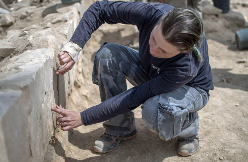  Archaeologist Daria Eladjem points to a ship drawing in the excavation. (credit: Yoli Schwartz, Antiquities Authority)