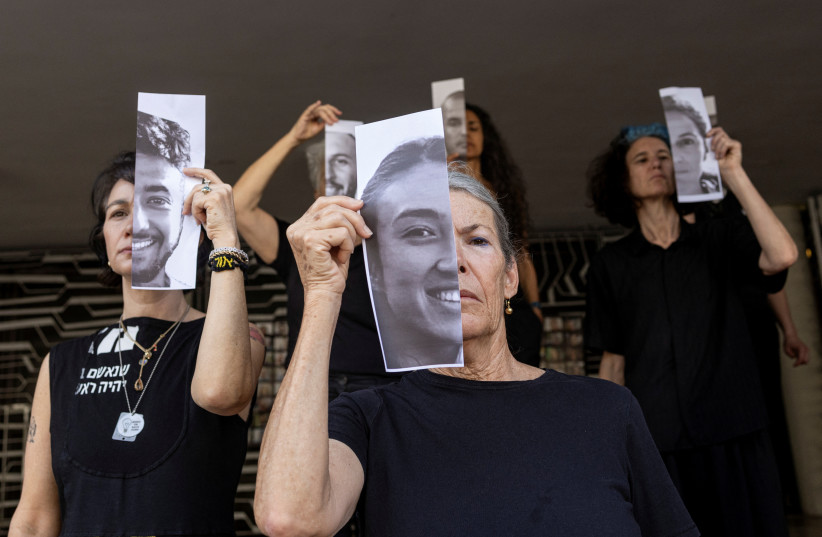 Relatives hold pictures of hostages kidnapped during the deadly October 7 attack, in Tel Aviv, Israel, May 23, 2024 (credit: REUTERS/MARKO DJURICA)