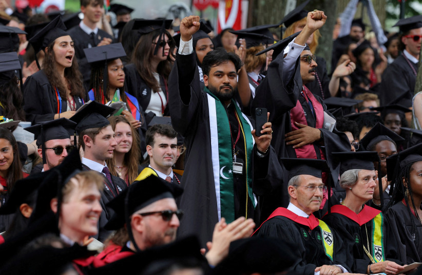  Graduating students rise in support of 13 students not able to graduate because of their participation in pro-Palestinian protests during the 373rd Commencement Exercises at Harvard University, amid the ongoing conflict between Israel and Hamas, May 23, 2024. (credit: BRIAN SNYDER/REUTERS)