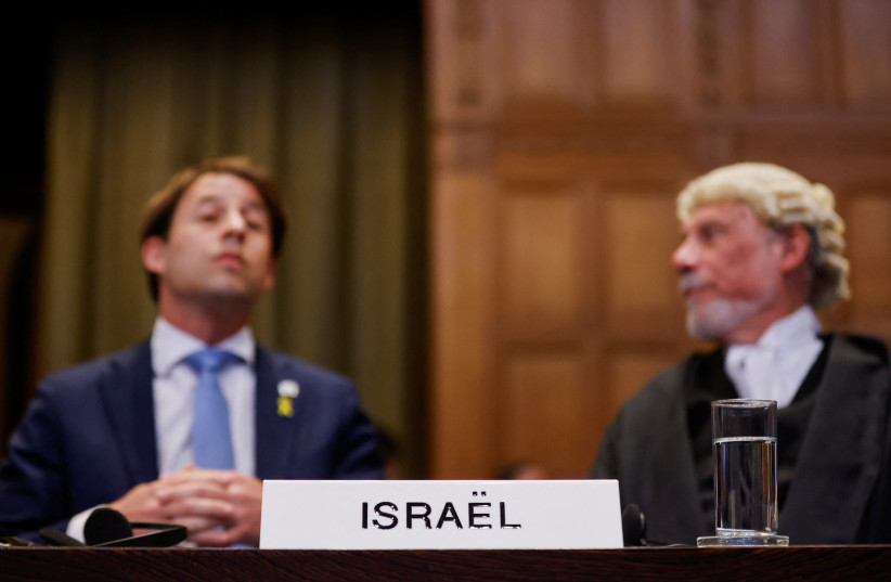 British jurist Malcolm Shaw and Yaron Wax look on at the International Court of Justice (ICJ), during a ruling on South Africa's request to order a halt to Israel's Rafah offensive in Gaza as part of a larger case brought before the Hague-based court by South Africa accusing Israel of genocide, in T (credit: JOHANNA GERON/REUTERS)