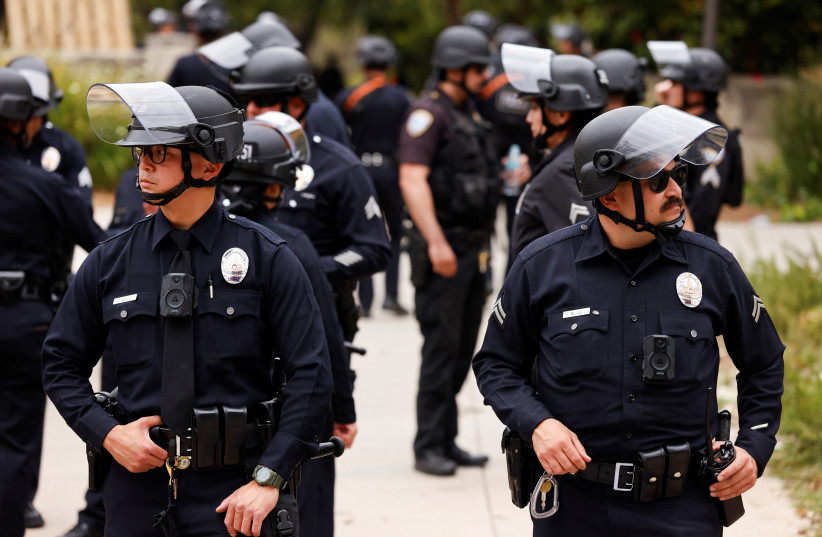  Police officers stand guard, on the day a pro-Palestinian activists' set up an encampment, at the University of California, Los Angeles (UCLA), amid the ongoing conflict between Israel and Palestinian Islamist group Hamas, in Los Angeles, California, US, May 23, 2024. (credit: REUTERS)