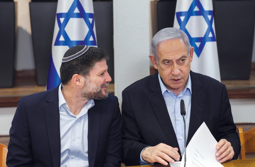  Prime Minister Benjamin Netanyahu speaks with Finance Minister Bezalel Smotrich during a cabinet meeting in Tel Aviv.  (credit: REUTERS/Ronen Zvulun/Pool)