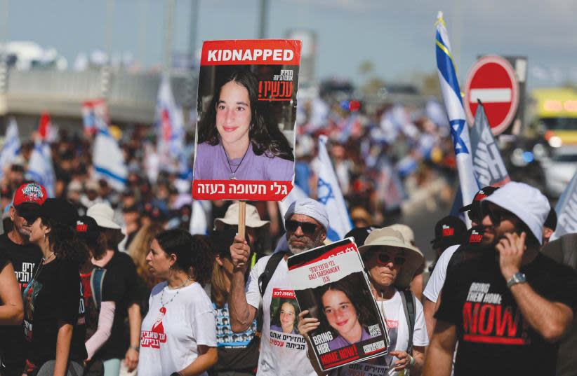 Family members, friends, and supporters o the hostages being held captive in Gaza march on the outskirts of Tel Aviv on their way to Jerusalem on November 15.