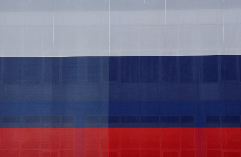 A large-size Russian state flag during celebrations of National Flag Day in Yevpatoriya, Crimea, August 22, 2023. (credit: REUTERS/ALEXEY PAVLISHAK)