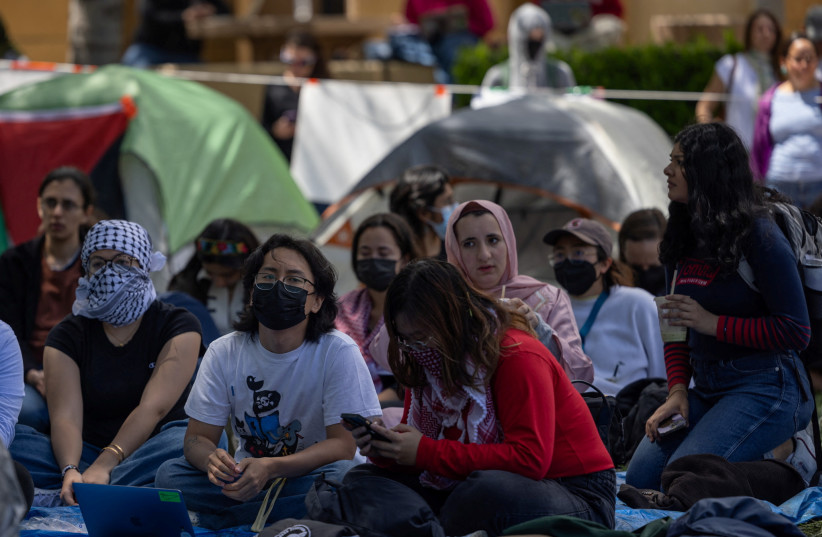  Students listen to a speech at a protest encampment in support of Palestinians at Stanford University during the ongoing conflict between Israel and the Palestinian Islamist group Hamas, in Stanford, California U.S., April 26, 2024.  (credit: CARLOS BARRIA / REUTERS)