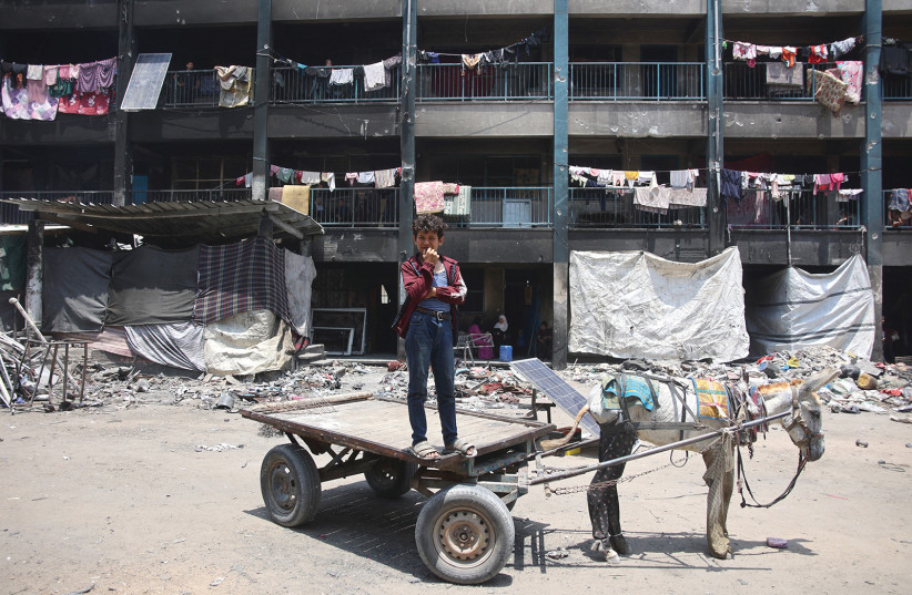 A PALESTINIAN youth stands on a donkey cart in the Jabalya refugee camp in northern Gaza. Who rules Gaza after the Israel-Hamas war is a question few can yet answer.