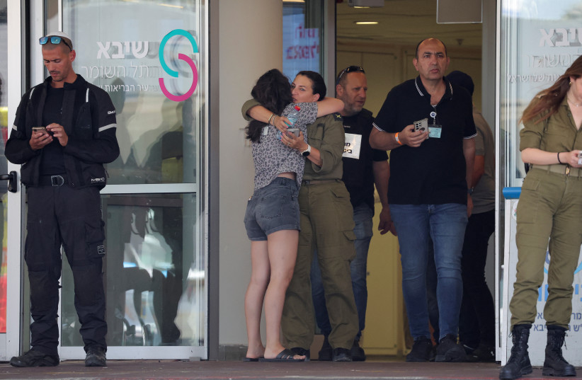 Families of hostages walk towards a hospital to meet with released hostages, in Ramat Gan