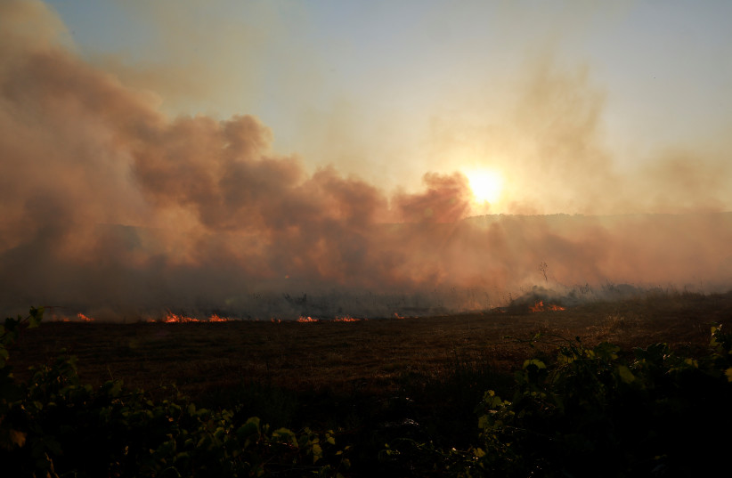  Smoke rises as flames burn, amid ongoing cross-border hostilities between Hezbollah and Israeli forces, in Dishon, near Kiryat Shmona, northern Israel, June 4, 2024.  (credit: REUTERS/AMMAR AWAD)