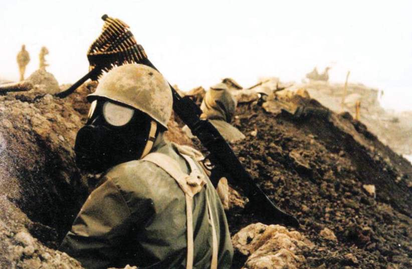  IRANIAN SOLDIER equipped with gas mask and M1 helmet during the war. (credit: WIKIPEDIA COMMONS)