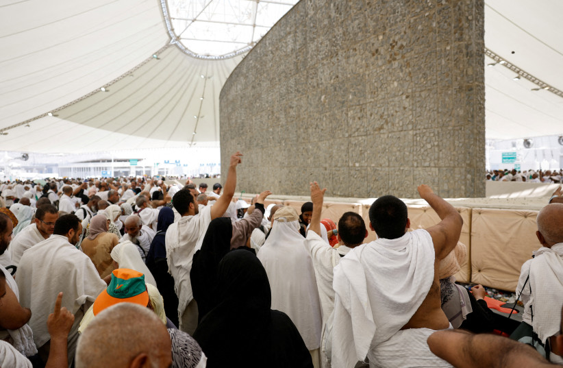 Muslim pilgrims cast their stones at a pillar symbolising Satan, during the annual haj pilgrimage in Mina, Saudi Arabia, June 16, 2024. (credit: MOHAMAD TOROKMAN/REUTERS)