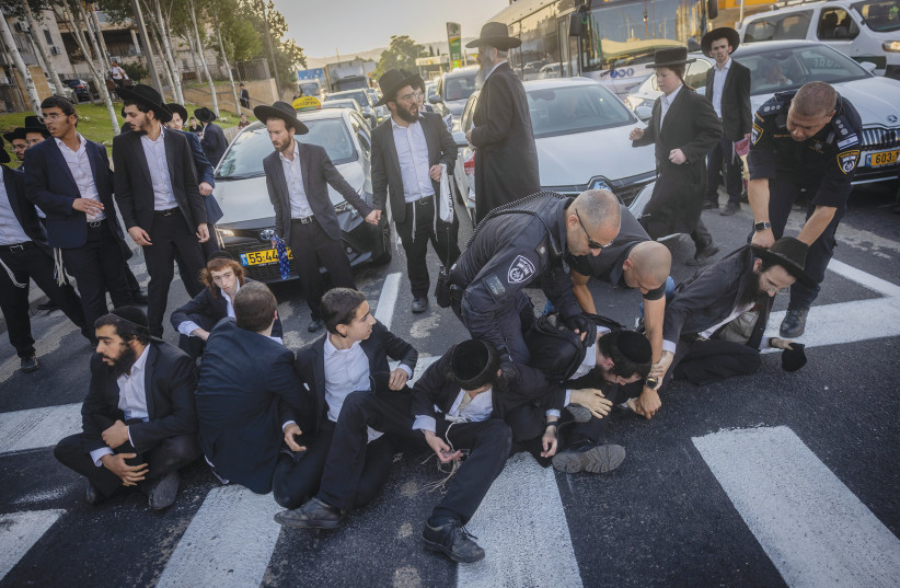  POLICE CONFRONT haredi demonstrators blocking a road in Jerusalem, protesting against efforts to draft haredim into the military, earlier this month. (credit: Chaim Goldberg/Flash90)