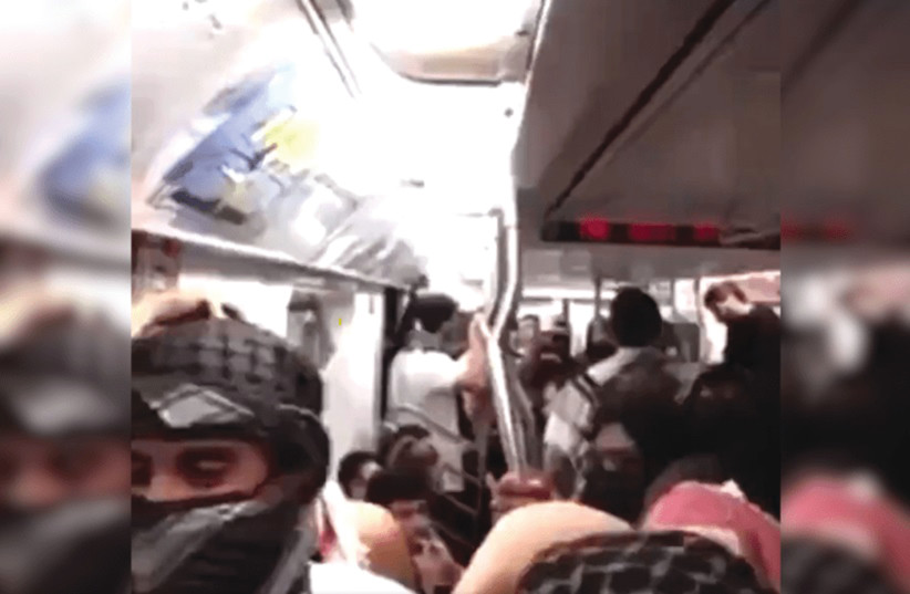  A PRO-PALESTINIAN mob aboard a New York City subway train demands that any Zionists who are present must raise their hands, last week. (credit: SCREENSHOT/X)