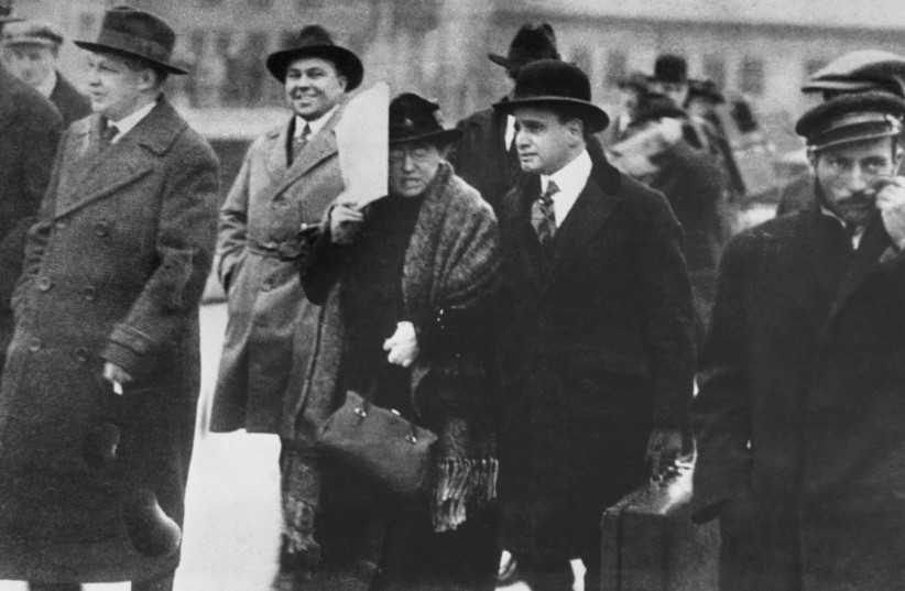 Emma Goldman with attorney Harry Weinberge second from (right) on the way to Ellis Island, where she and her former lover Alexander Berkman would be among 249 ''anarchist aliens'' deported en masse to Russia by the U.S. government, Dec. 6, 1919. (credit:
