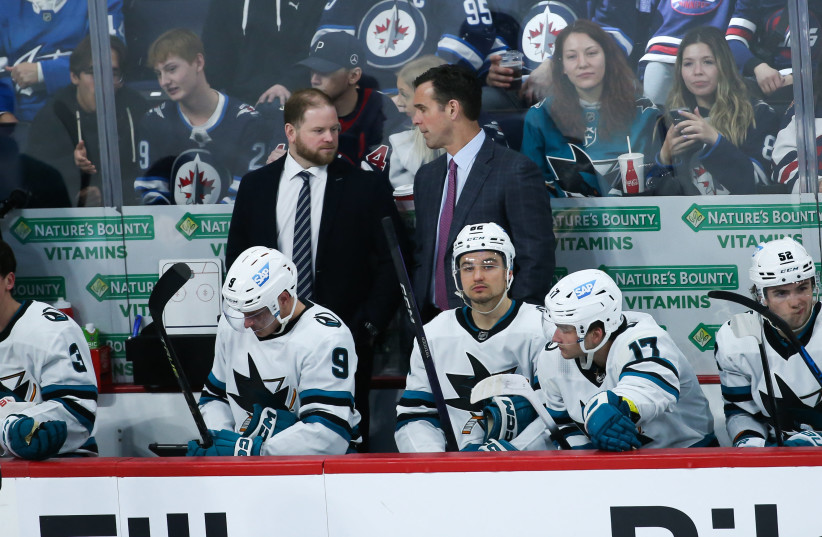  Apr 10, 2023; Winnipeg, Manitoba, CAN; San Jose Sharks coach David Quinn talks with with assistant coach Ryan Warsofsky during the third period against the Winnipeg Jets at Canada Life Centre. (credit: Terrence Lee-USA TODAY Sports)