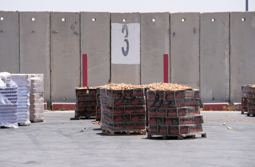  Crates of yellow onions await delivery into Gaza at the Kerem Shalom crossing in southern Israel on June 17, 2024. (credit: REUTERS/NATHAN FRANDINO)
