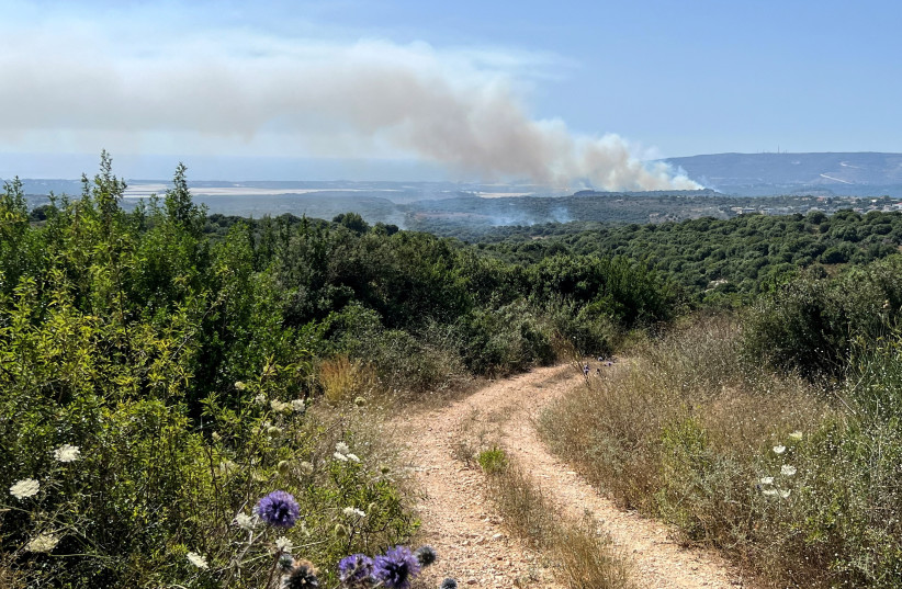  Smoke rises above the Israeli side of the Israel-Lebanon border following attacks from Lebanon, amid cross-border hostilities between Hezbollah and Israeli forces, in northern Israel June 18, 2024.  (credit: REUTERS/Avi Ohayon)