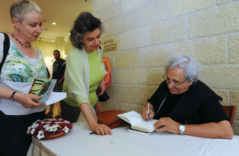  A.B. YEHOSHUA signs a book at the Jerusalem International Writers Festival in the capital’s Mishkenot Sha’ananim in 2010. (credit: Moshe Milner/GPO)