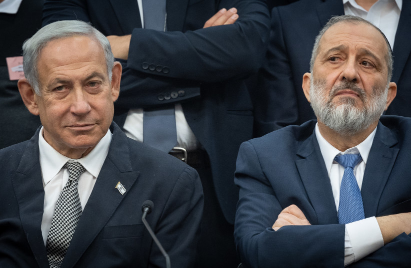  Shas leader MK Arye Deri and Prime Minister Benjamin Netanyahu seen at the Knesset, in Jerusalem, on January 23, 2023 (credit: YONATAN SINDEL/FLASH90)