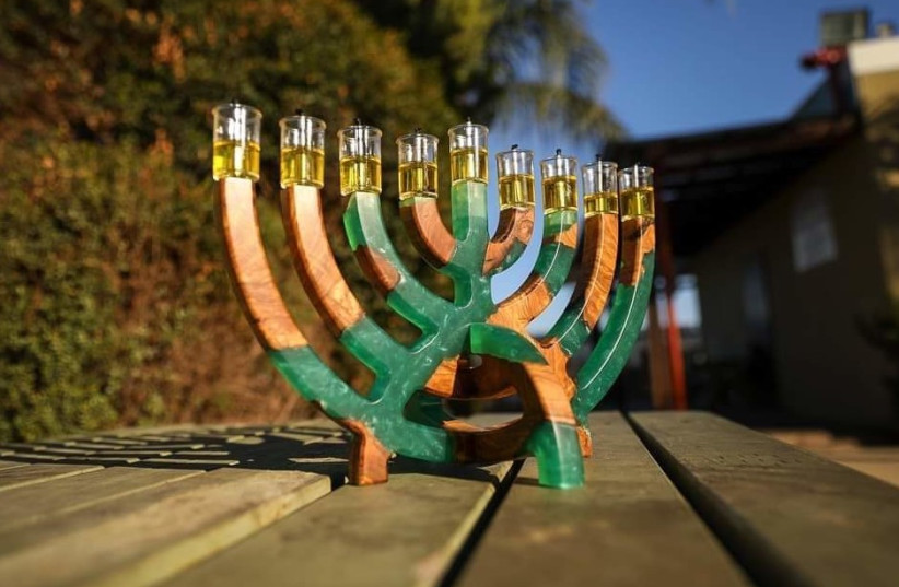  A unique olive wood / green resin chanukiah to embellish the Holiday of Light. (credit: Nadav Pollack)