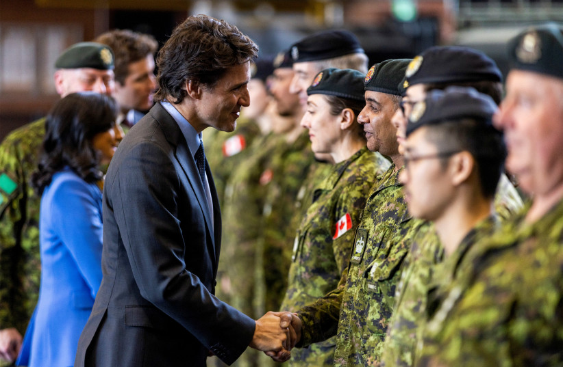 Canada's Prime Minister Justin Trudeau shakes hands with members of Canadian Armed Forces in Toronto, Ontario, Canada February 24, 2023. (credit: REUTERS/CARLOS OSORIO)