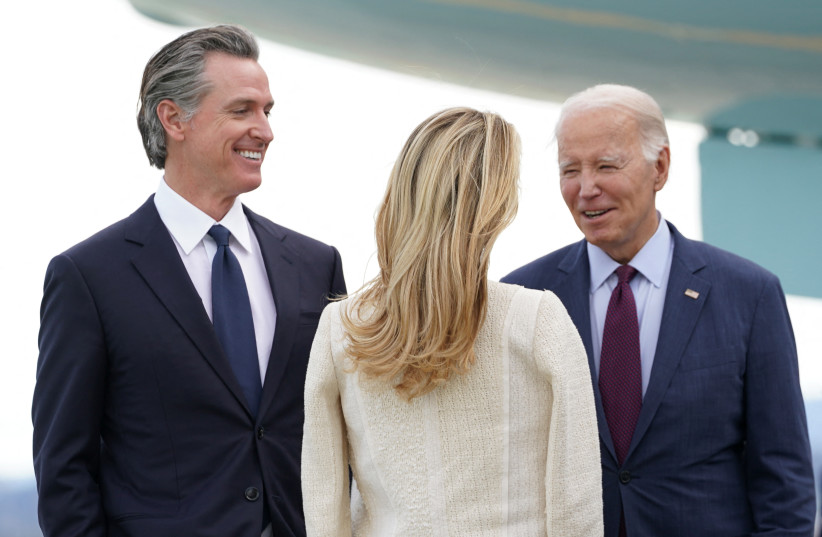 US President Joe Biden is greeted by California Governor Gavin Newsom and his wife Jennifer Siebel Newsom as he arrives to host the Asia-Pacific Economic Cooperation (APEC) summit, in San Francisco, California, US, November 14, 2023. (credit: REUTERS/KEVIN LAMARQUE)