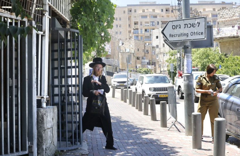  An ultra-Orthodox Jewish man is seen exiting an IDF recruiting office in Jerusalem, June 25, 2024 (credit: MARC ISRAEL SELLEM/THE JERUSALEM POST)