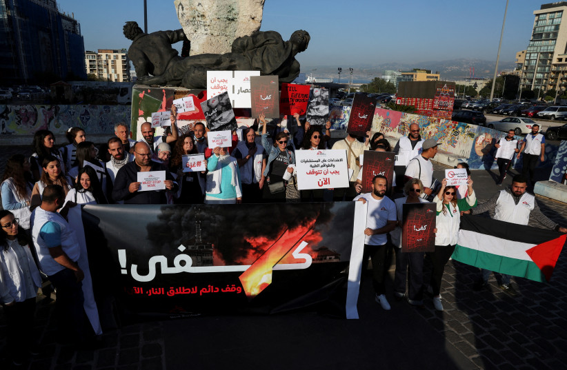  Members of MSF, Medecins Sans Frontieres (Doctors Without Borders), carry banners and flags during a protest demanding an immediate and permanent ceasefire in Gaza, at Martyrs' Square, downtown Beirut, Lebanon, December 4, 2023. (credit: REUTERS/EMILIE MADI)