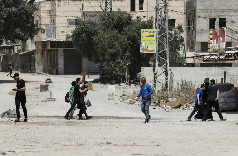  Palestinos caminan, en Yenín, Cisjordania, el 21 de mayo de 2024.  (credit: REUTERS/RANEEN SAWAFTA)