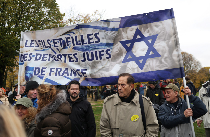  People hold a banner that reads ''The sons and daughters of the Jews deported from France'' during a demonstration against antisemitism organised by the two heads of the French Parliament. Paris, France November 12, 2023.  (credit: REUTERS/CLAUDIA GRECO)